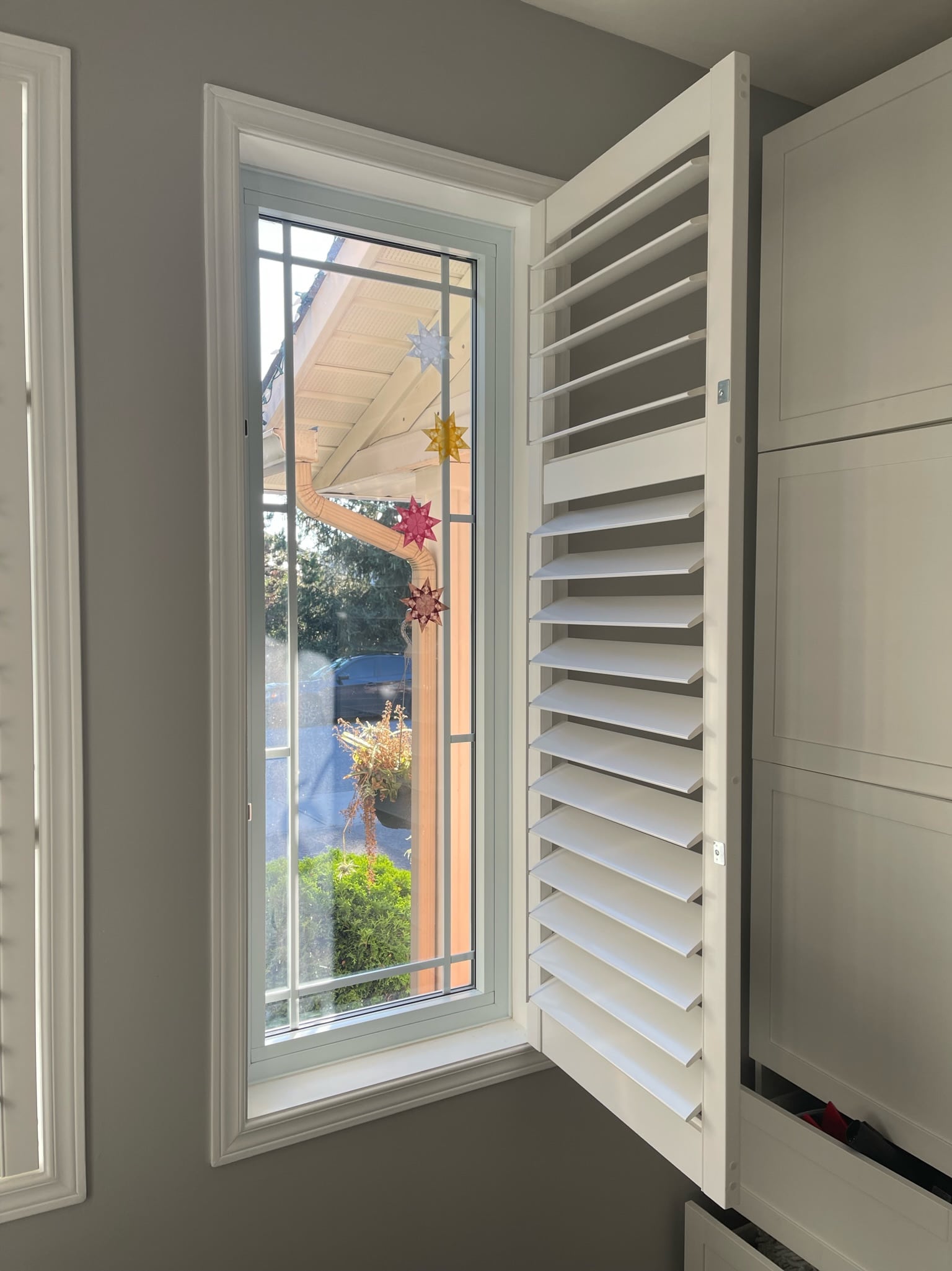 Elegant white California shutters installed in an Ottawa home, providing stylish light control and energy efficiency.